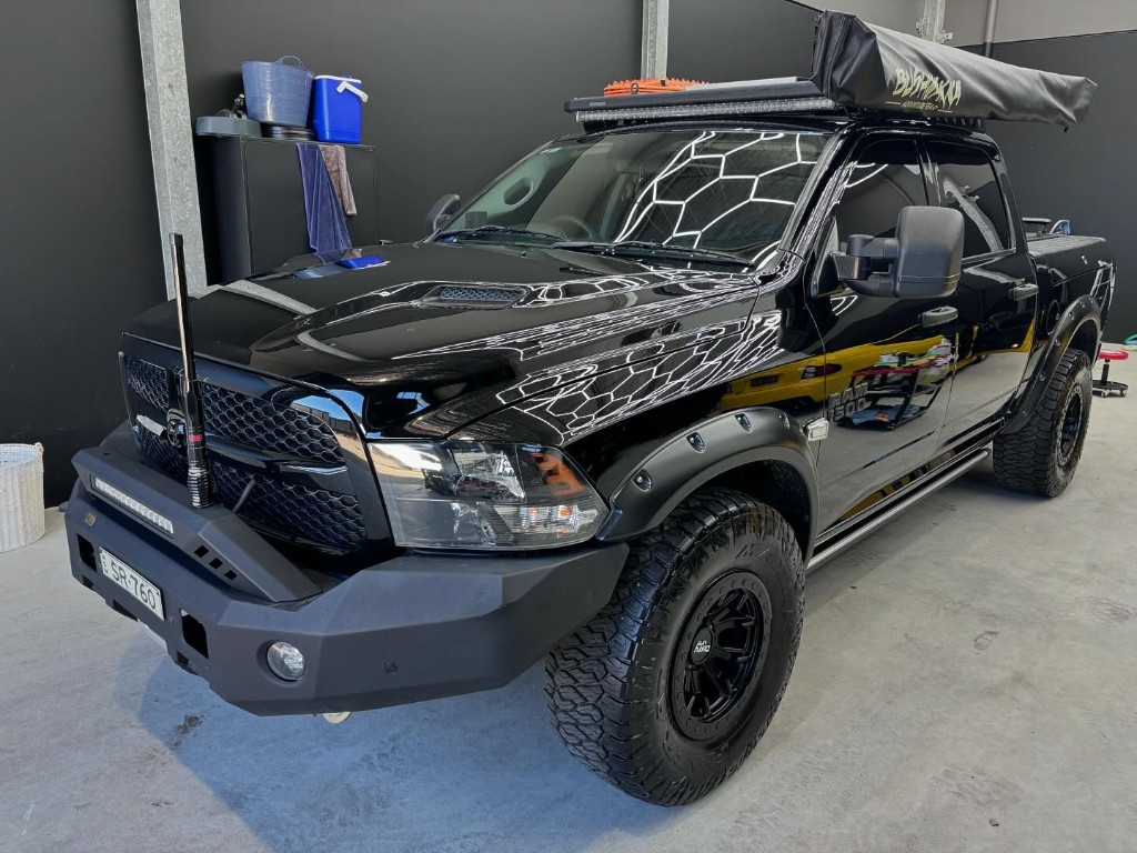 RAM 1500 before and after ceramic paint protection in workshop, after