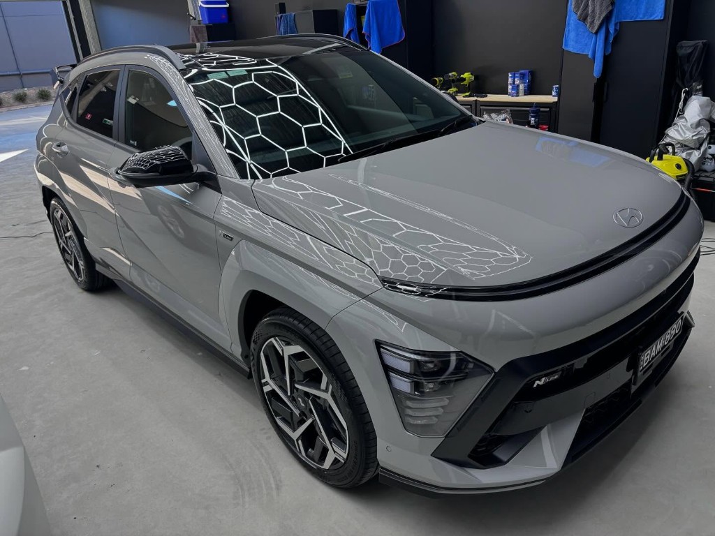 Black Hyundai Palisade SUV ceramic coated in workshop