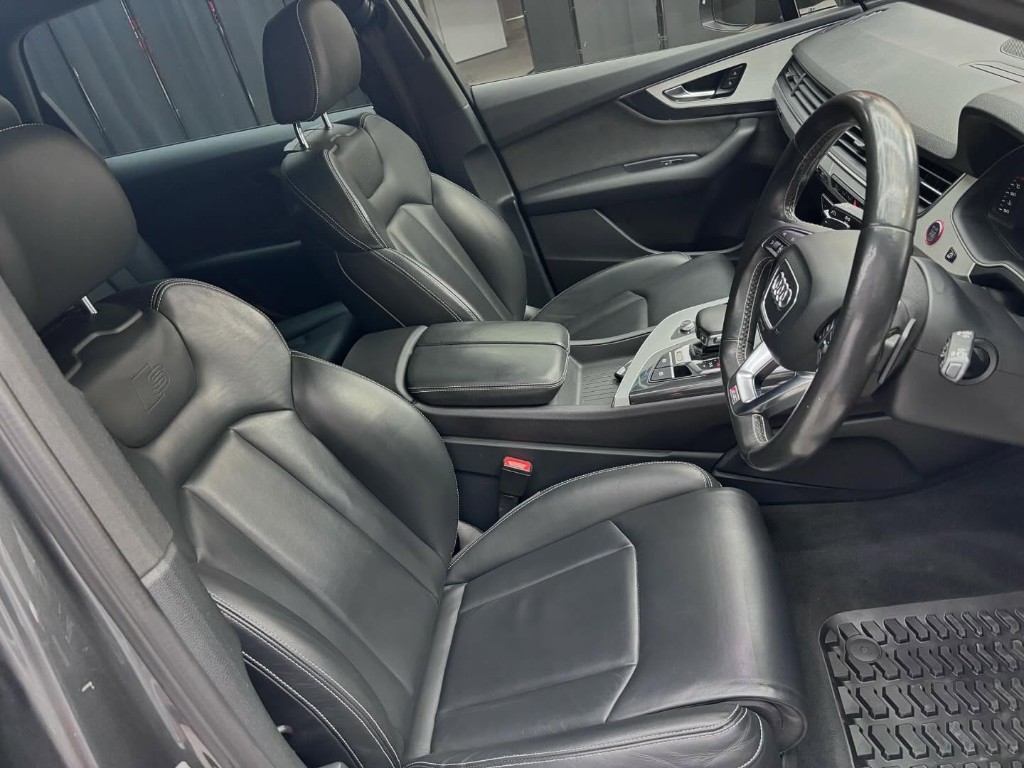 White performance sedan with mirror gloss in detailing studio