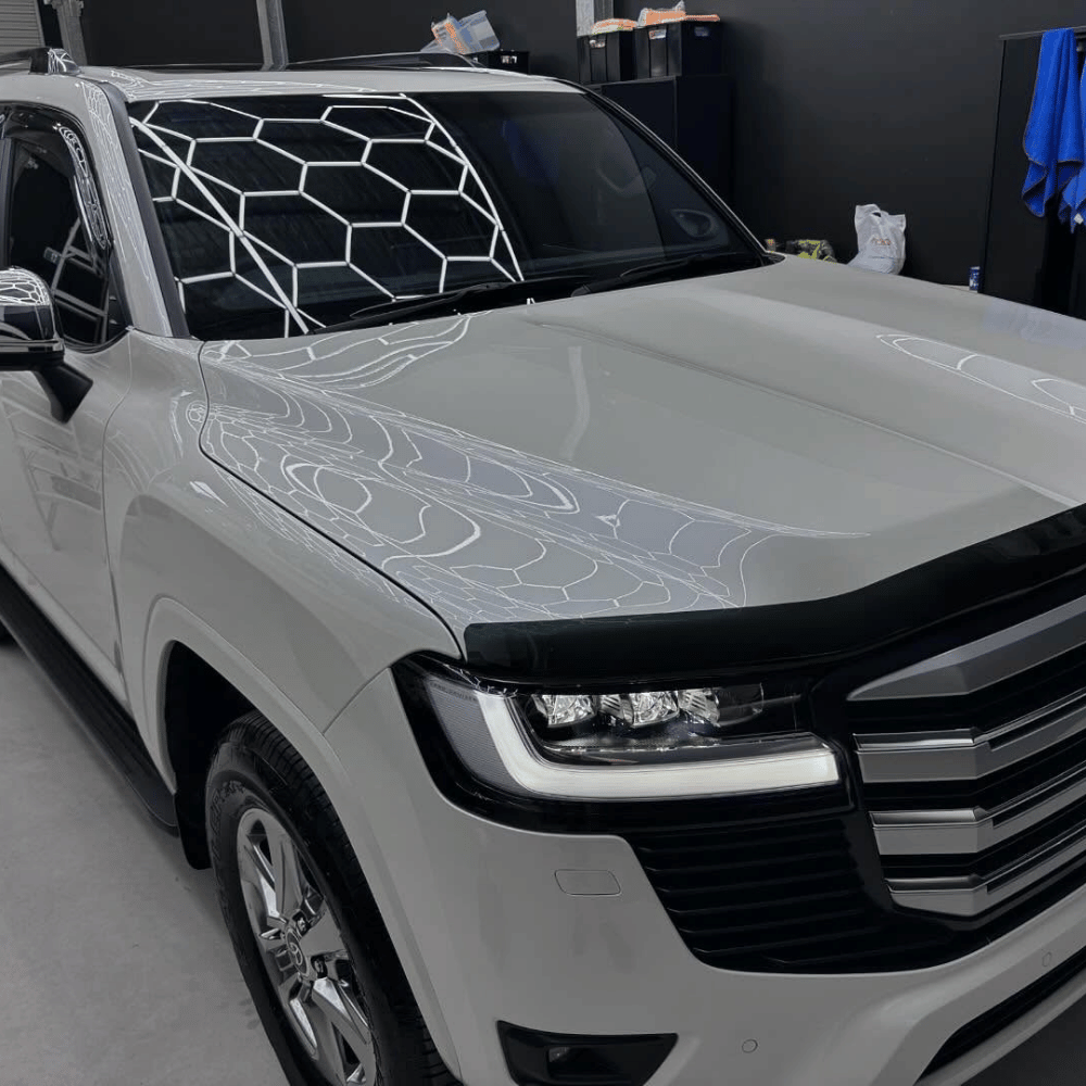 White Toyota Land Cruiser with ceramic paint protection gloss in workshop