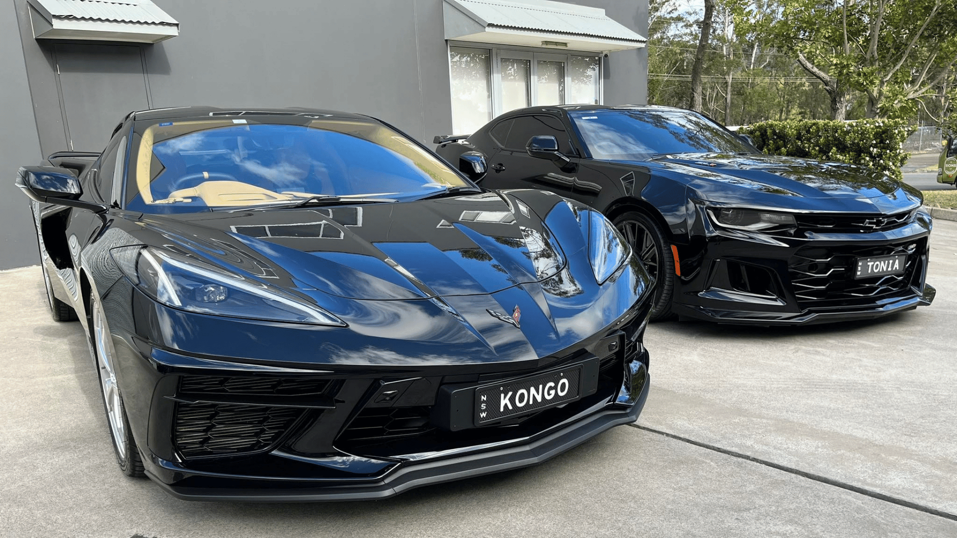 Black Corvette and Camaro with ceramic paint protection gloss in Coastline Car Detailing workshop